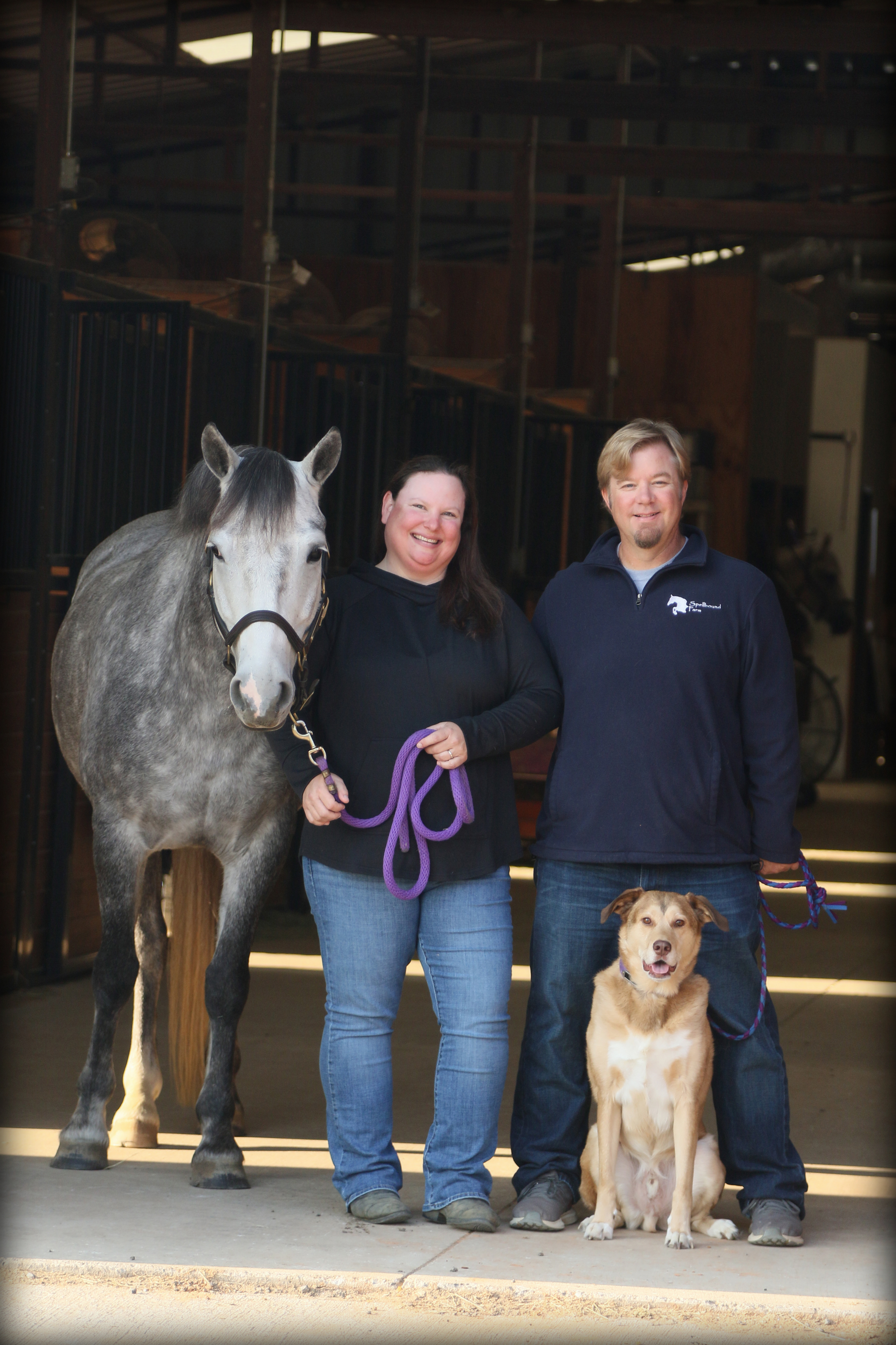 Photo of Tracey, Jay and Austin in the barn aisle