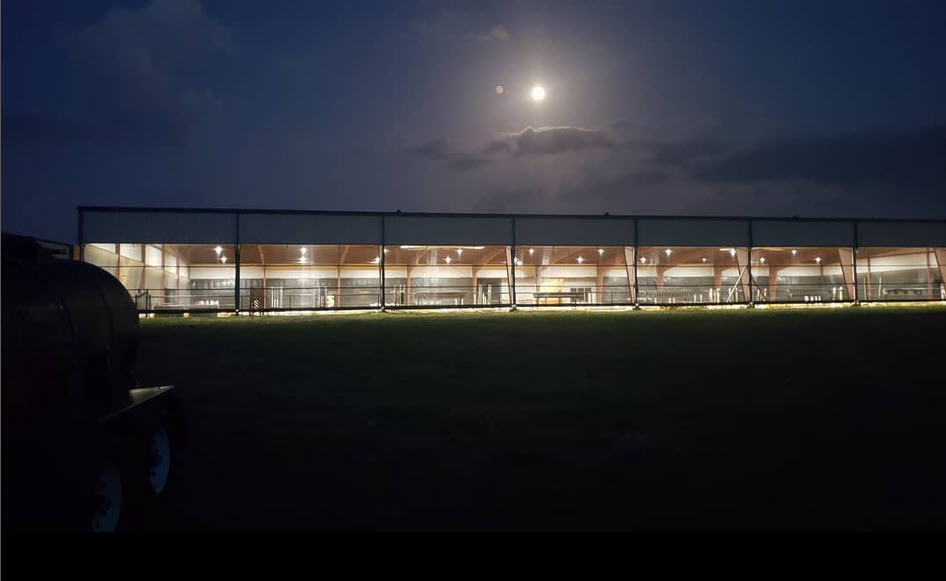 Photo of the indoor arena at night with a bright moon overhead